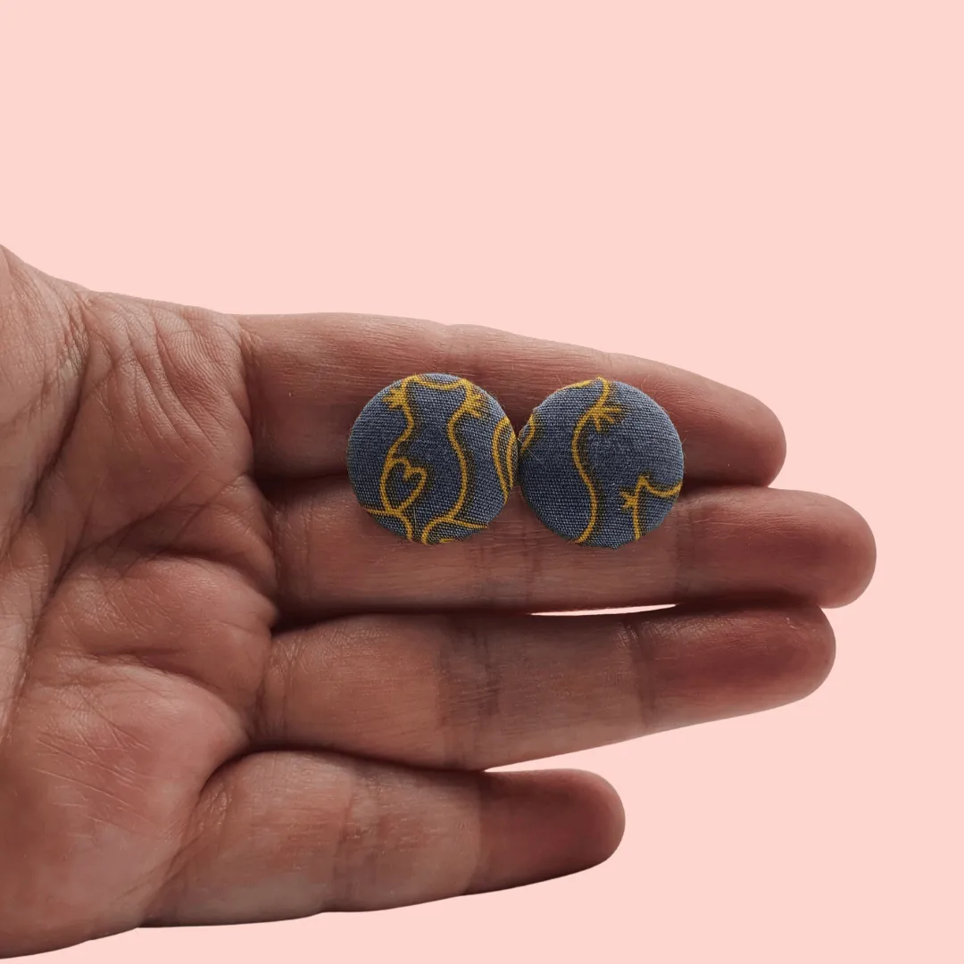 Grey fabric button studs with yellow cat design.
