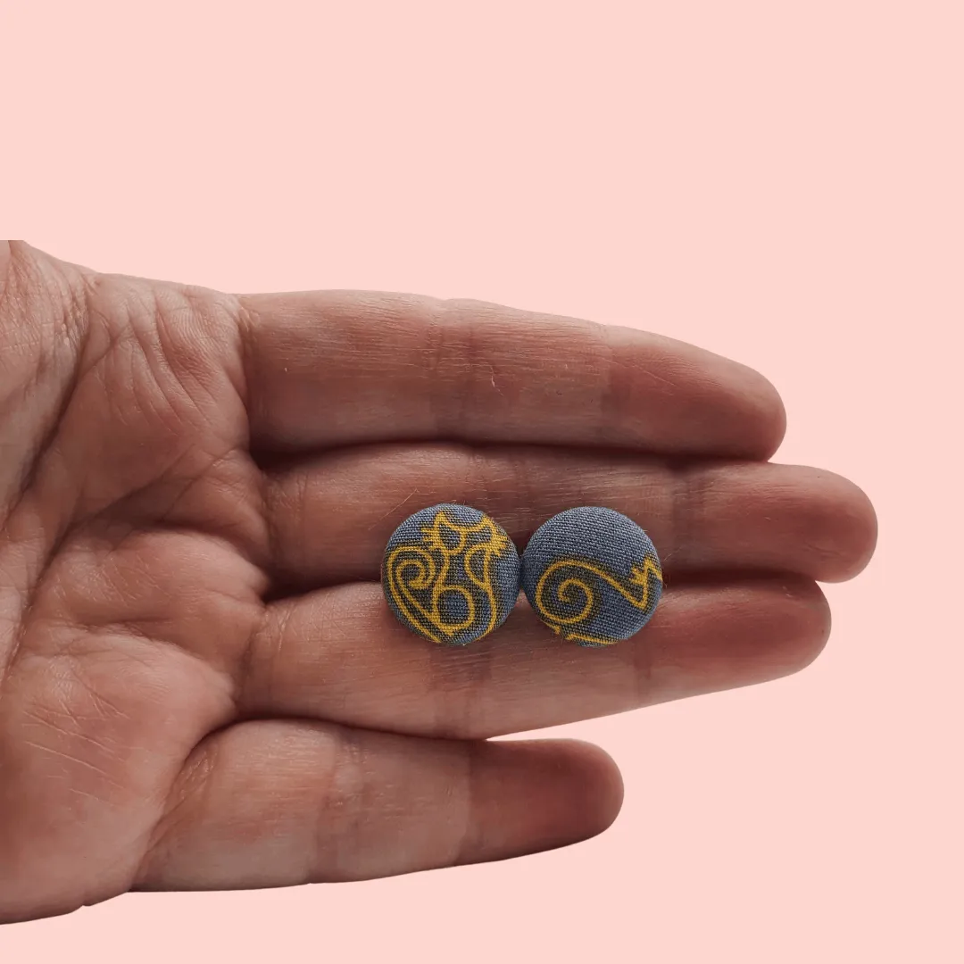 Grey fabric button studs with yellow cat design.