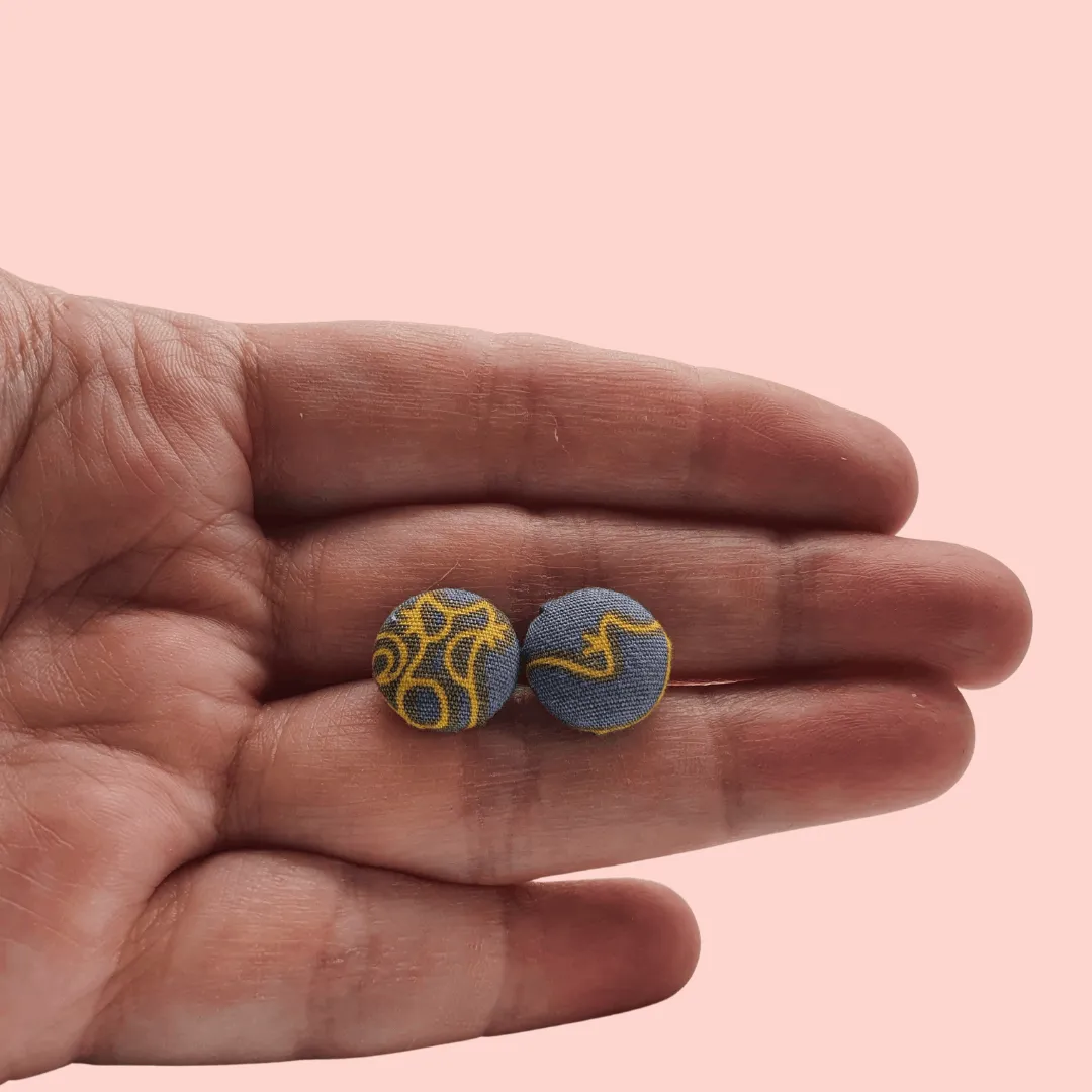 Grey fabric button studs with yellow cat design.