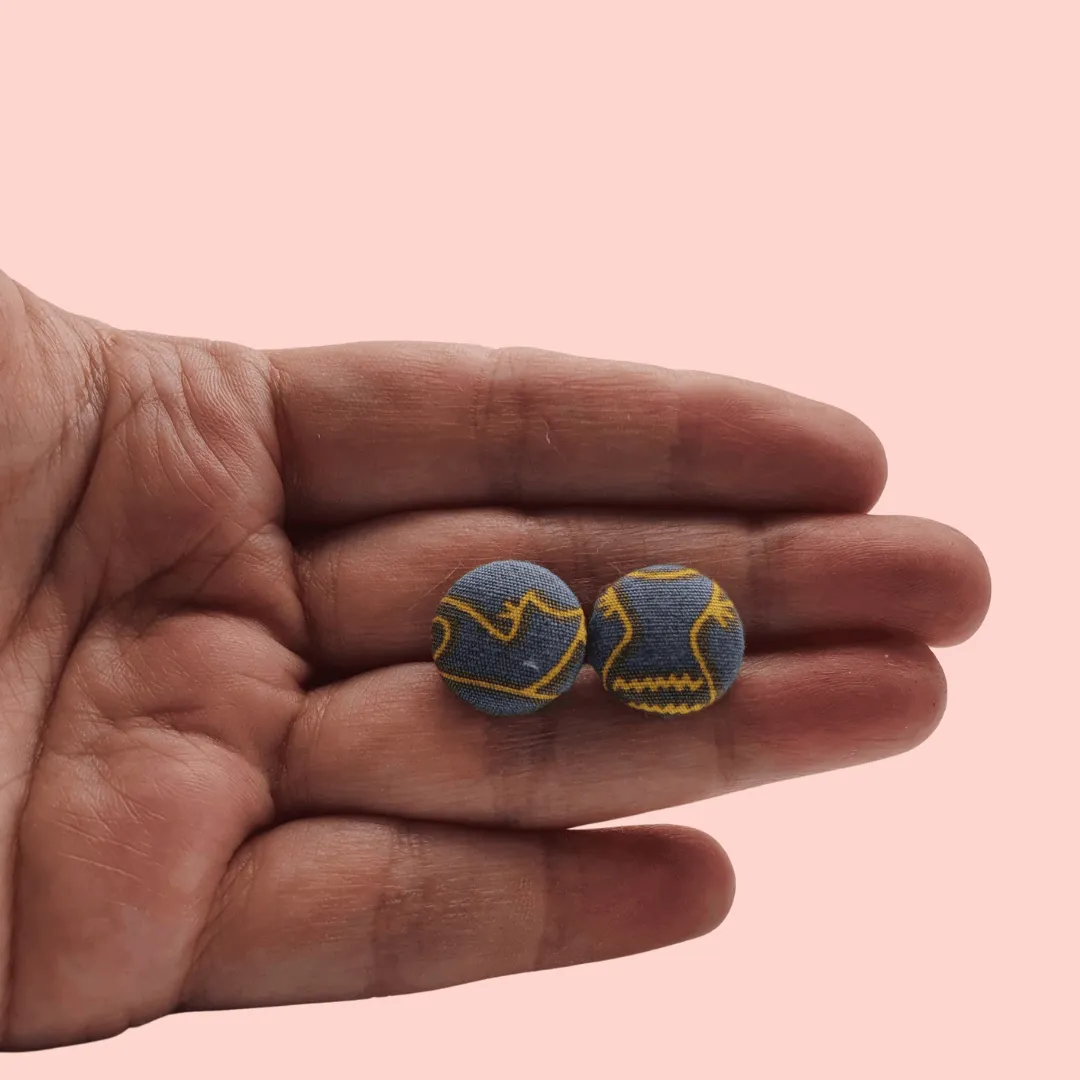 Grey fabric button studs with yellow cat design.