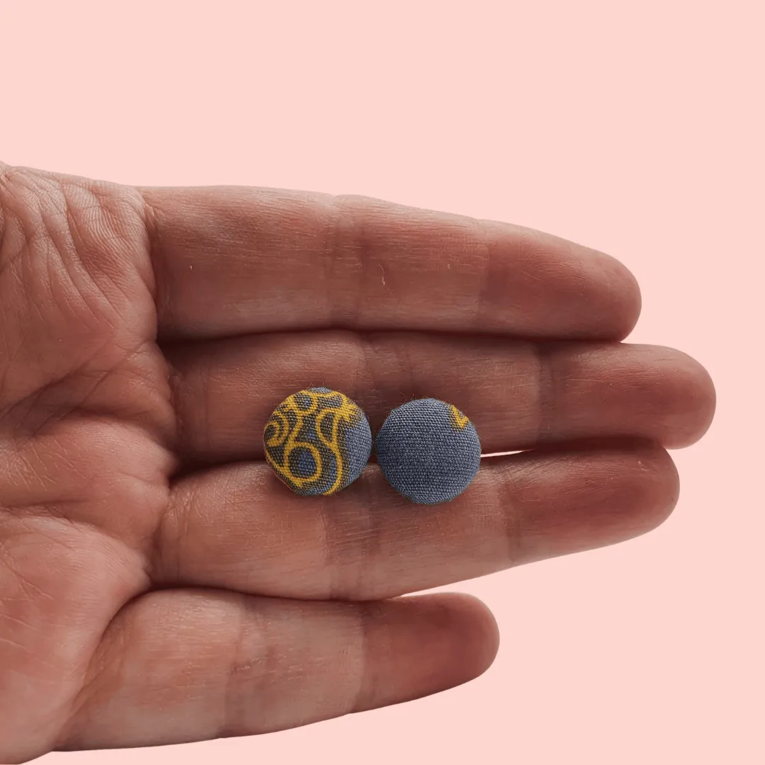 Grey fabric button studs with yellow cat design.