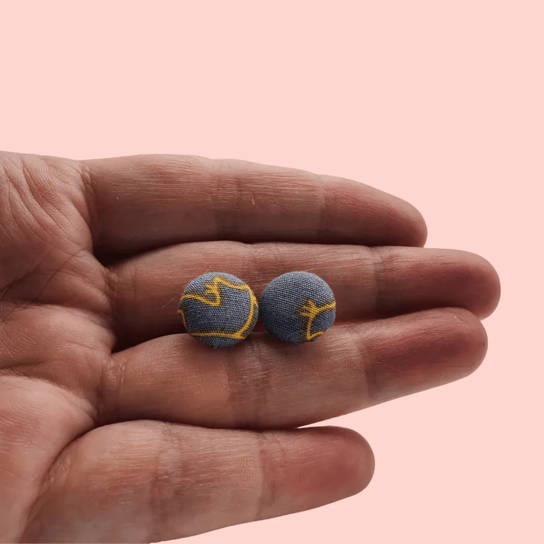 Grey fabric button studs with yellow cat design.