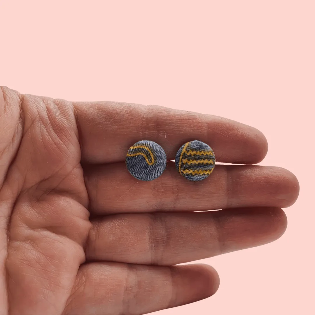 Grey fabric button studs with yellow cat design.