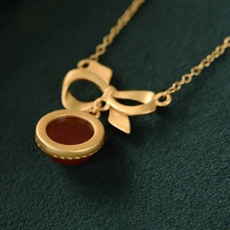 inlaid with southern red tourmaline round bow pendant ladies necklace